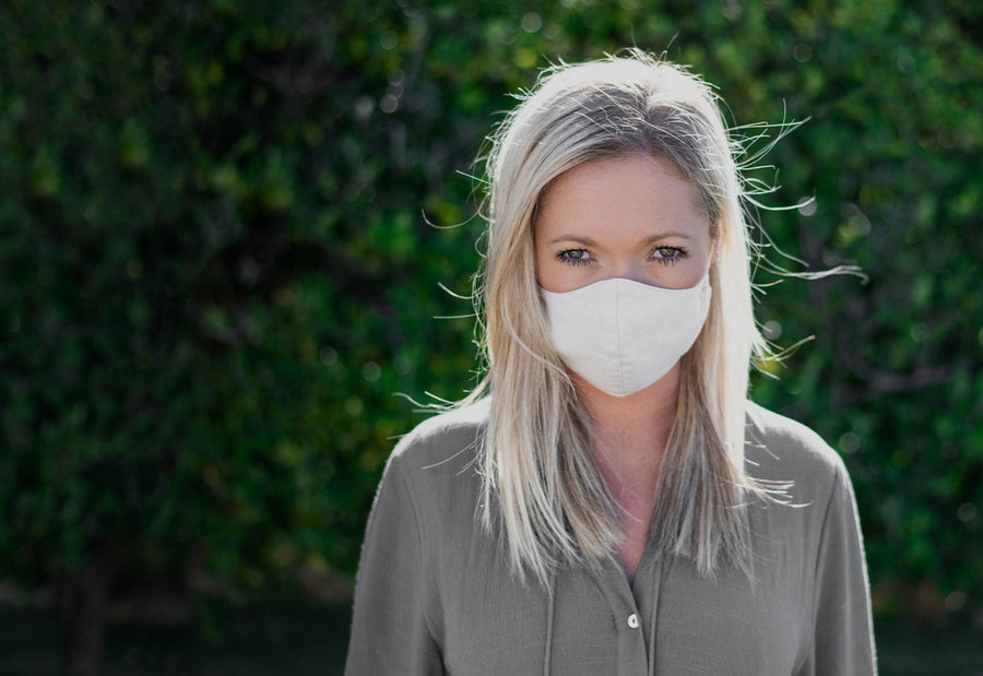 Woman Wearing a Kind Face Reusable Linen Face Mask in Natural Colour