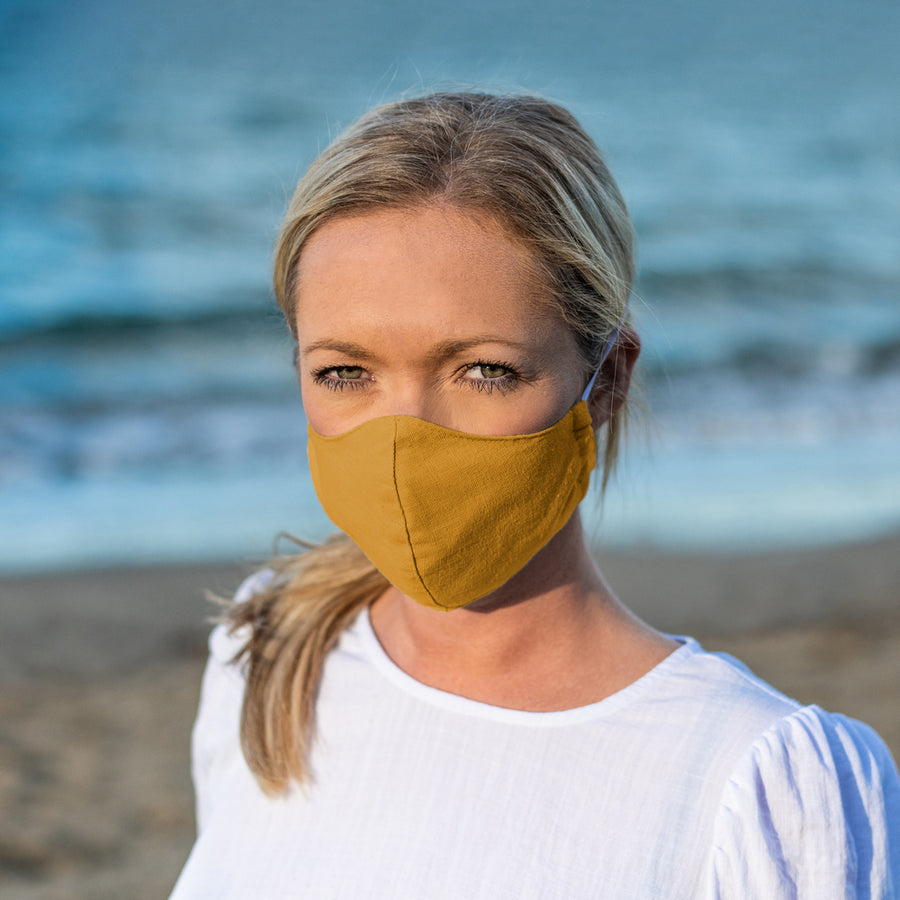Woman Wearing a Kind Face Reusable Linen Face Mask in Golden Harvest Colour
